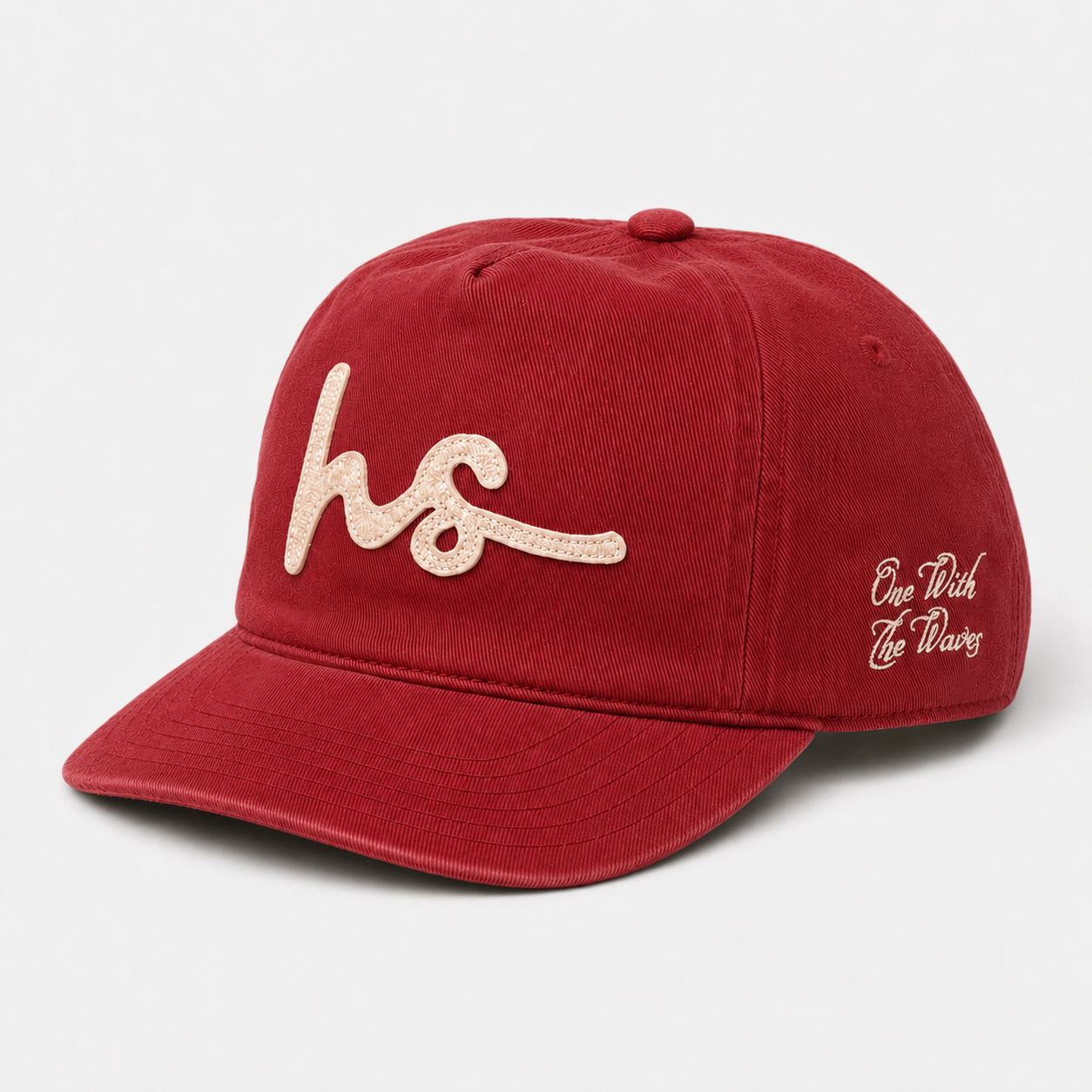 A red baseball cap with a curved brim, featuring a textured beige embroidered script logo on the front and 'One Truth Two Ways' in matching beige embroidery on the side, set against a light gray background.